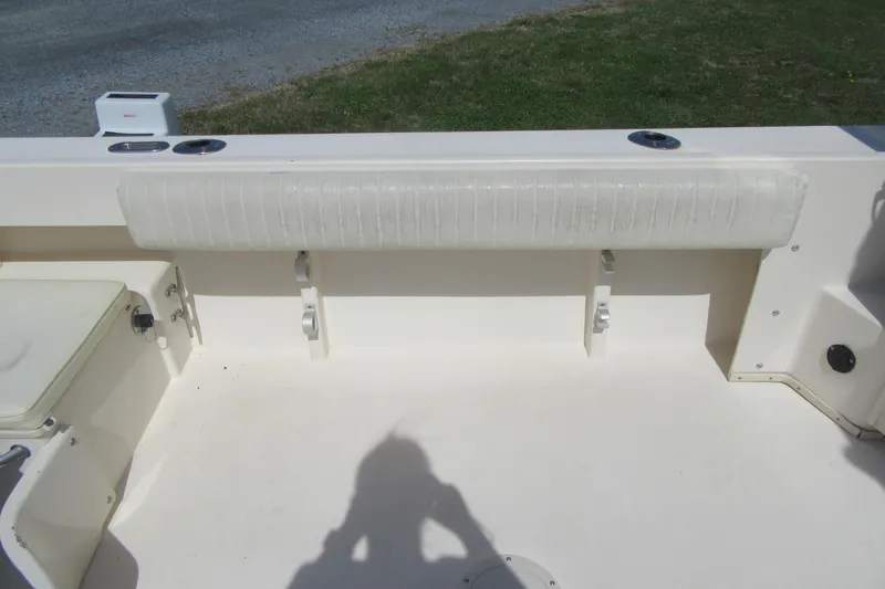 Slide: The Image of 2006 Parker 2120 Sport Cabin boat interior with cushioned seating and storage compartments. - 11