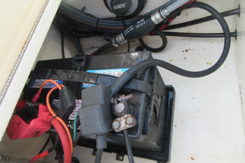 Slide: The Image of Battery compartment of a 2006 Parker 2120 Sport Cabin boat with cables and connections. - 12
