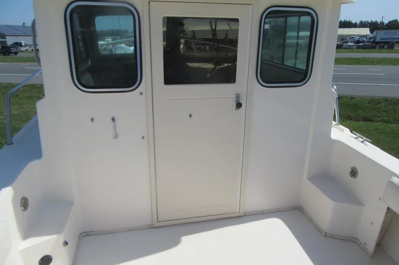 Slide: The Image of 2006 Parker 2120 Sport Cabin boat exterior with cabin door and windows. - 14