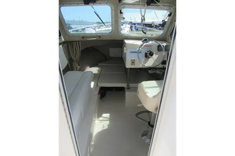 Slide: The Image of Interior of a 2006 Parker 2120 Sport Cabin boat with steering wheel and seating. - 23