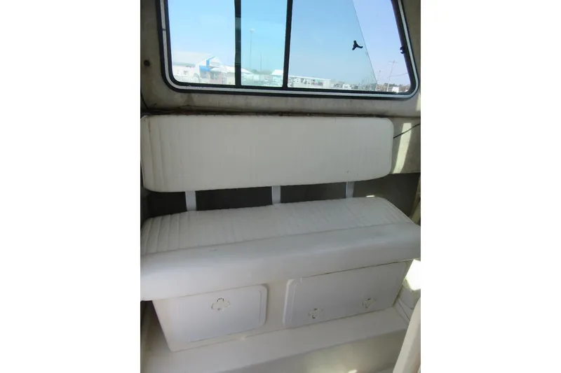 Slide: The Image of Interior seating of 2006 Parker 2120 Sport Cabin boat with window view. - 26