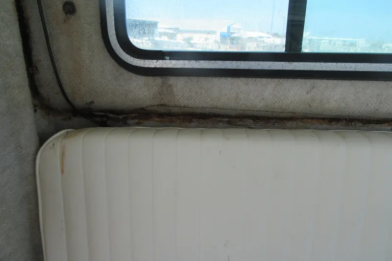 Slide: The Image of Interior view of a 2006 Parker 2120 Sport Cabin boat window and seat. - 27