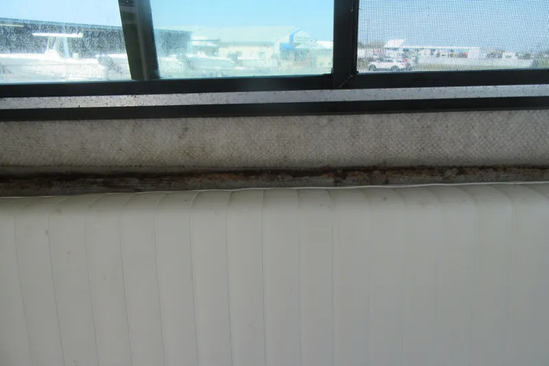 Slide: The Image of Interior view of a 2006 Parker 2120 Sport Cabin boat window and seating. - 28