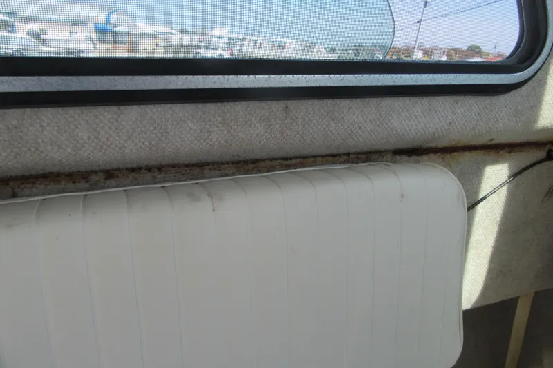 Slide: The Image of Interior view of a 2006 Parker 2120 Sport Cabin boat window and seat. - 29