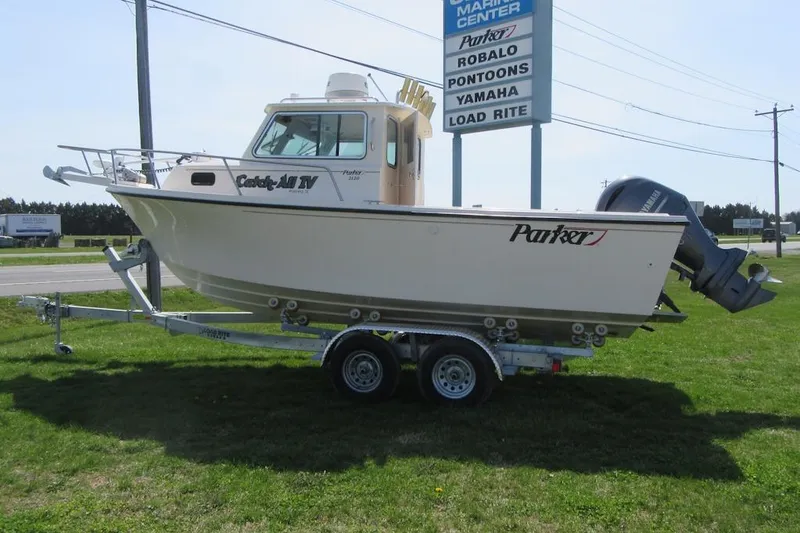 Slide: The Image of 2006 Parker 2120 Sport Cabin boat on trailer at marine center. - 3