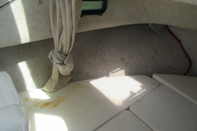 Slide: The Image of Interior cabin of 2006 Parker 2120 Sport Cabin boat with cushions and curtain. - 31