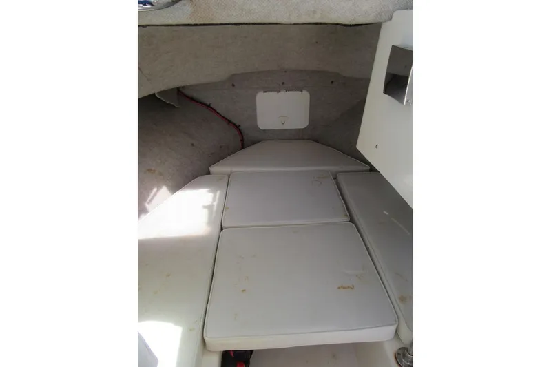 Slide: The Image of Interior cabin of 2006 Parker 2120 Sport Cabin boat with cushioned seating. - 32