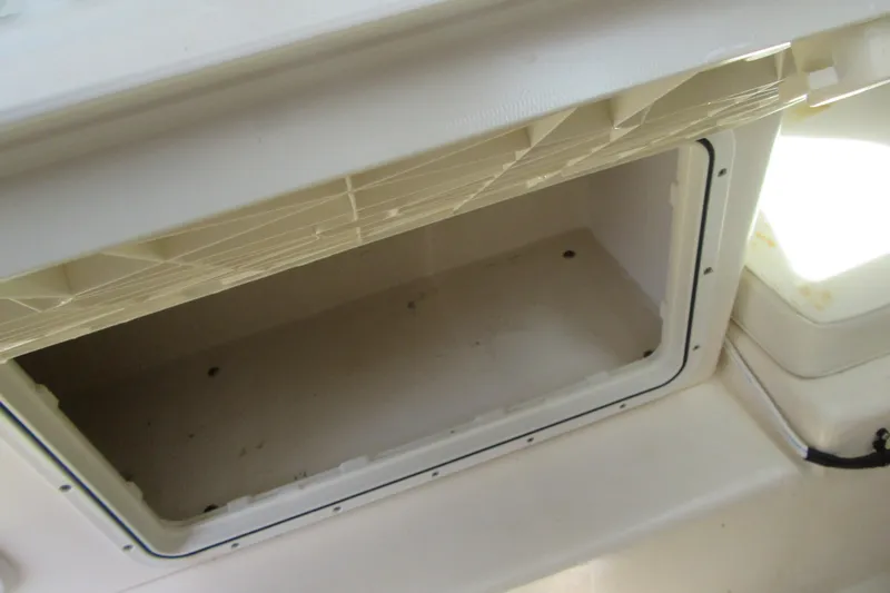 Slide: The Image of Storage compartment inside a 2006 Parker 2120 Sport Cabin boat, open and empty. - 35