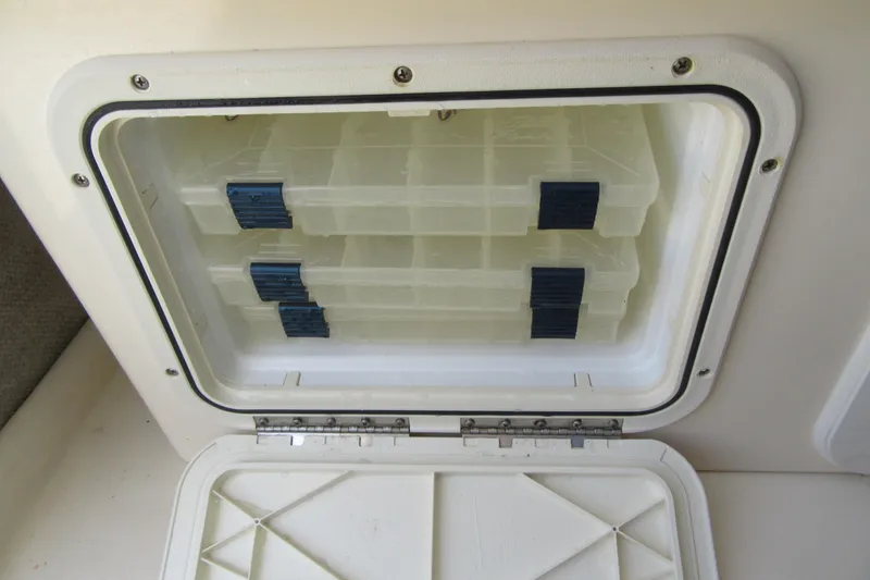 Slide: The Image of Storage compartment with tackle boxes in a 2006 Parker 2120 Sport Cabin boat. - 36
