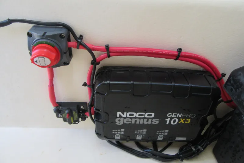 Slide: The Image of NOCO Genius GENPRO 10X3 charger with red cables in a 2006 Parker 2120 Sport Cabin. - 38