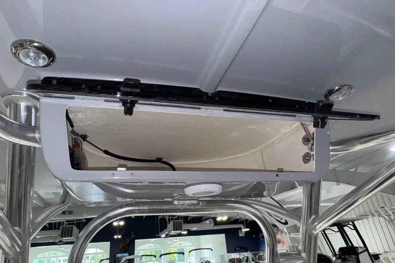 Slide: The Image of 2026 Key West 230 Bay Reef boat interior, featuring a storage compartment and sleek design elements. - 19