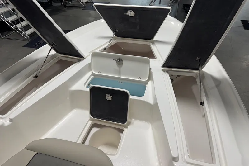 Slide: The Image of 2026 Key West 230 Bay Reef boat with open storage compartments and seating area. - 8