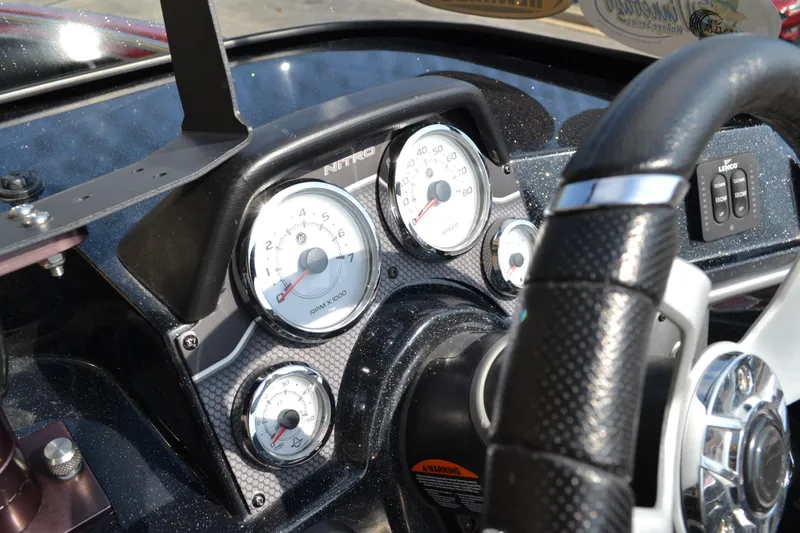 Slide: The Image of Dashboard of a 2022 Nitro ZV20 boat with gauges and steering wheel. - 11