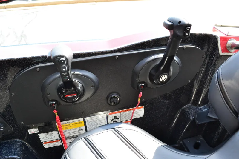 Slide: The Image of 2022 Nitro ZV20 boat controls with dual levers and safety lanyards. - 12