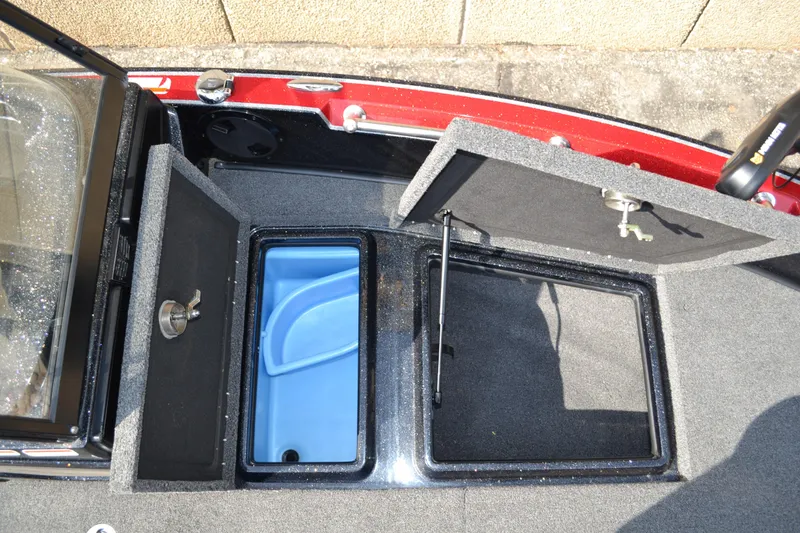 Slide: The Image of Open storage compartments on a 2022 Nitro ZV20 boat, featuring a blue interior. - 19