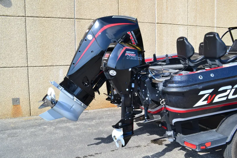 Slide: The Image of 2022 Nitro ZV20 boat with Mercury Pro Kicker engine, parked outdoors. - 2