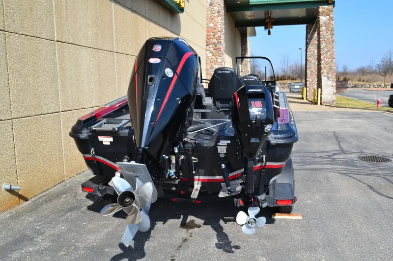 Slide: The Image of 2022 Nitro ZV20 boat with dual Mercury outboard motors, parked outdoors. - 3