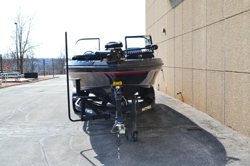Slide: The Image of 2022 Nitro ZV20 boat on trailer, parked beside a building on a sunny day. - 5