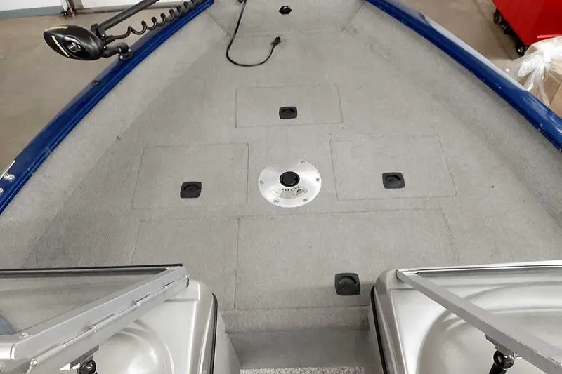 Slide: The Image of 2013 Tracker Pro Guide V-16 WT boat interior with gray carpet and storage compartments. - 14