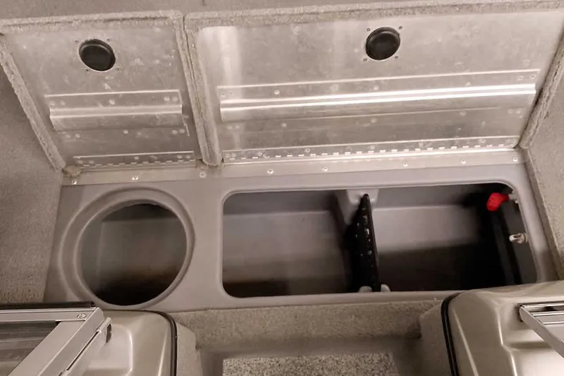 Slide: The Image of 2013 Tracker Pro Guide V-16 WT boat storage compartments with metal lids and circular openings. - 15