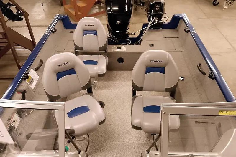 Slide: The Image of 2013 Tracker Pro Guide V-16 WT boat interior with four seats and motor. - 21