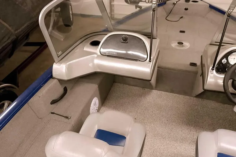 Slide: The Image of Interior of a 2013 Tracker Pro Guide V-16 WT boat with seating and dashboard. - 22