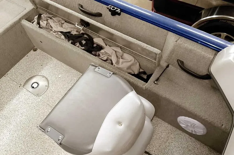 Slide: The Image of 2013 Tracker Pro Guide V-16 WT boat interior with storage compartment and seat. - 24