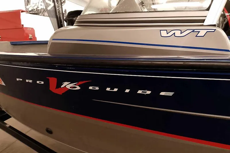 Slide: The Image of 2013 Tracker Pro Guide V-16 WT boat, close-up of model name and design. - 3