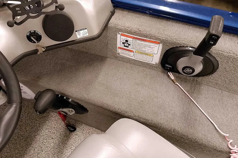 Slide: The Image of 2013 Tracker Pro Guide V-16 WT boat interior with steering and control panel. - 31