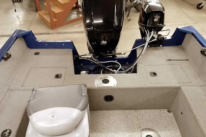 Slide: The Image of 2013 Tracker Pro Guide V-16 WT boat interior with motor and seating. - 33