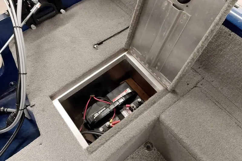 Slide: The Image of 2013 Tracker Pro Guide V-16 WT boat battery compartment with open hatch. - 34