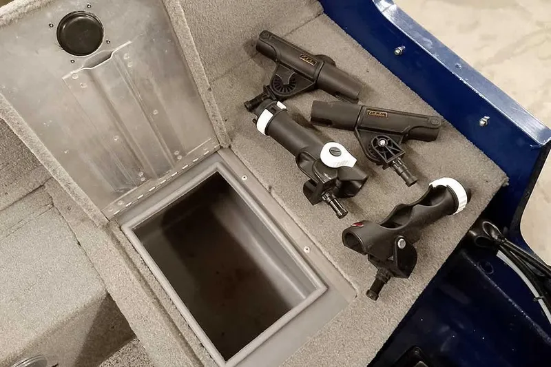 Slide: The Image of 2013 Tracker Pro Guide V-16 WT boat interior with rod holders and storage compartment. - 35