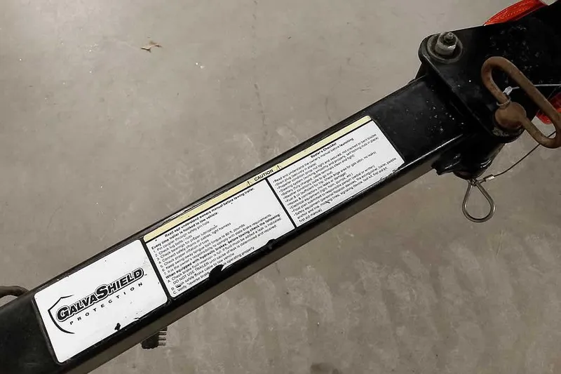 Slide: The Image of Trailer hitch with GalvaShield protection label on a 2013 Tracker Pro Guide V-16 WT. - 37