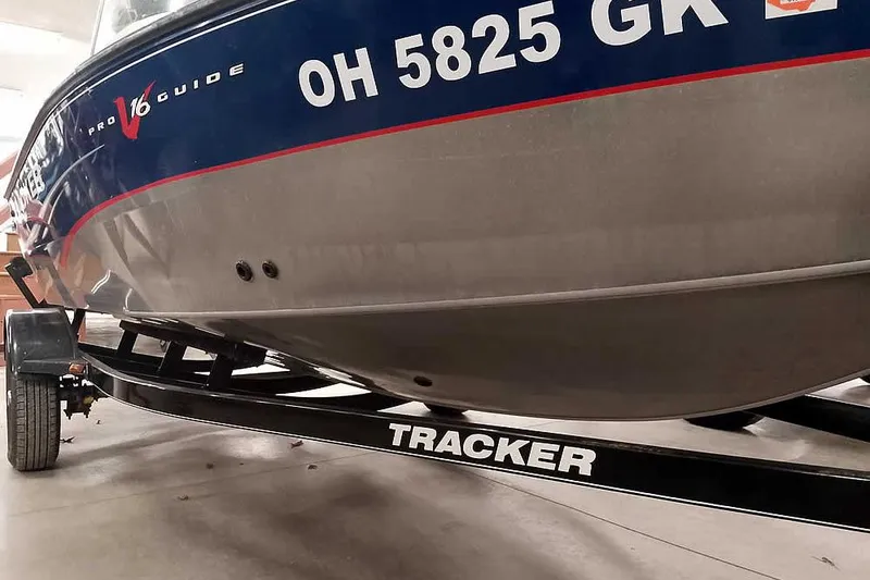 Slide: The Image of 2013 Tracker Pro Guide V-16 WT boat on trailer, displaying registration number OH 5825 GK. - 6
