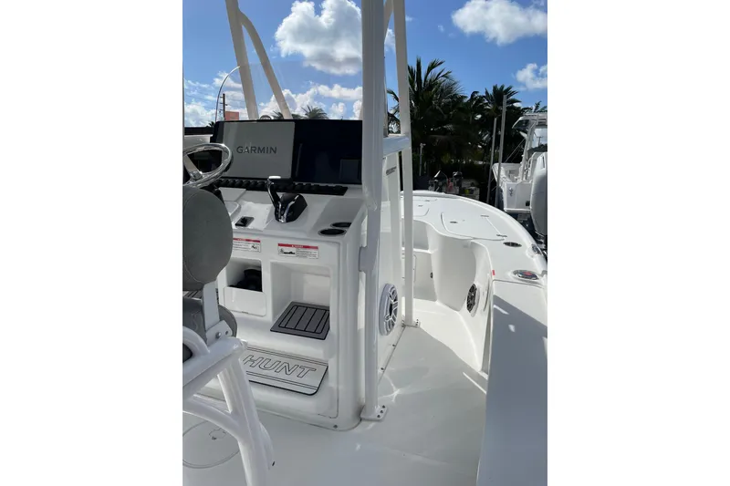 Slide: The Image of 2024 Sea Hunt BX 22 BR boat interior with Garmin navigation system, under a clear blue sky. - 10