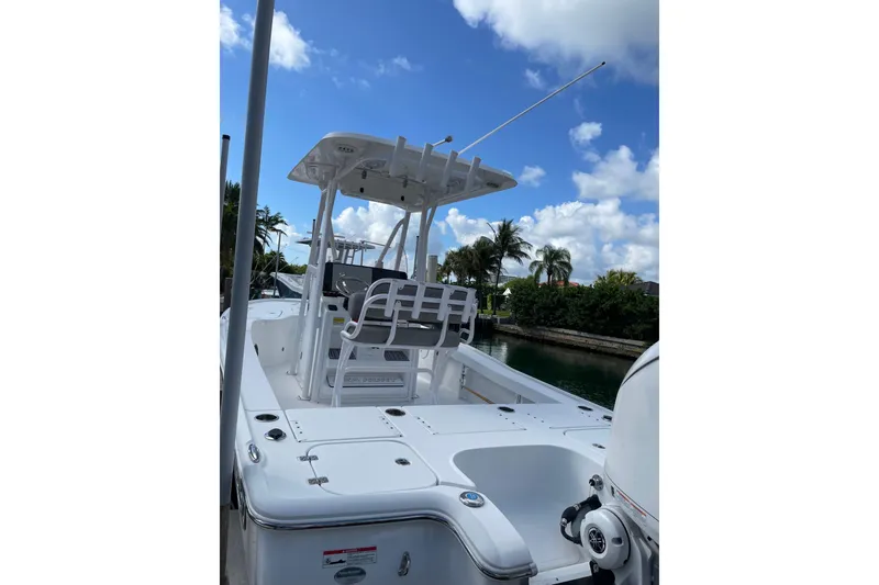 Slide: The Image of 2024 Sea Hunt BX 22 BR boat docked under a clear blue sky. - 3