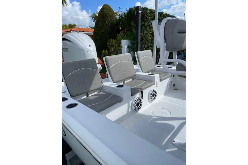 Slide: The Image of 2024 Sea Hunt BX 22 BR boat interior with gray seating and speakers. - 7