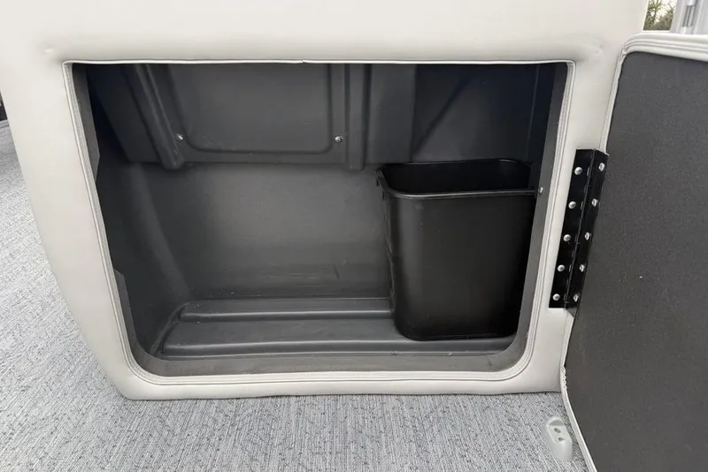 Slide: The Image of Storage compartment with trash bin in 2026 Sun Tracker Fishin' Barge 20 DLX boat. - 12