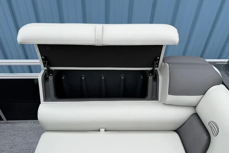 Slide: The Image of 2026 Sun Tracker Fishin' Barge 20 DLX storage compartment with open cushioned seat. - 13