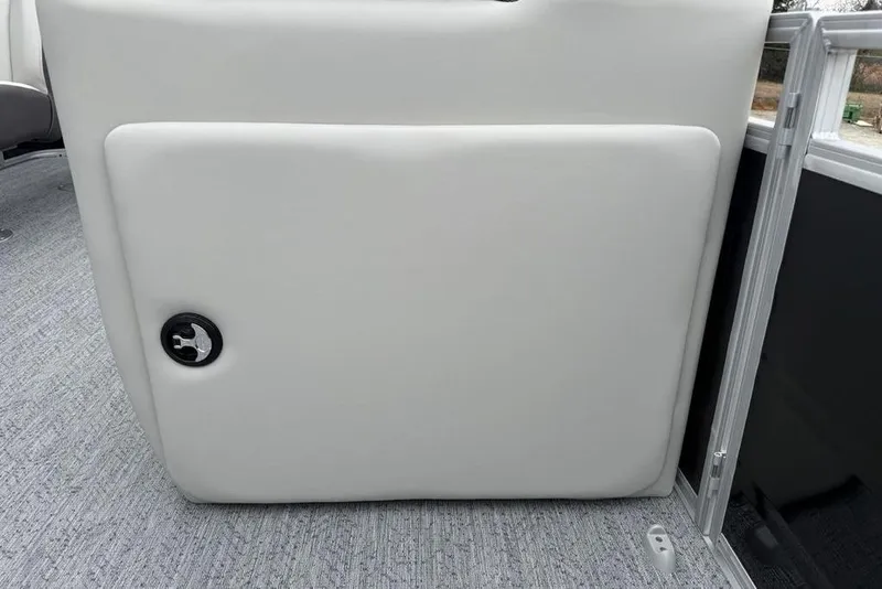 Slide: The Image of 2026 Sun Tracker Fishin' Barge 20 DLX interior detail with white upholstery and lock. - 14