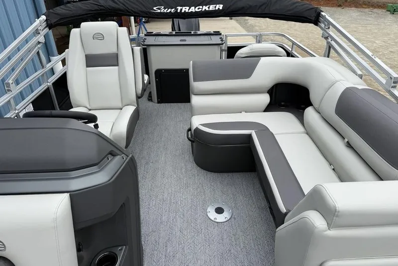 Slide: The Image of 2026 Sun Tracker Fishin' Barge 20 DLX interior with plush seating and modern design. - 16