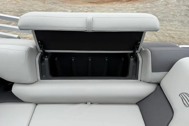 Slide: The Image of Open storage compartment on 2026 Sun Tracker Fishin' Barge 20 DLX boat seat. - 20