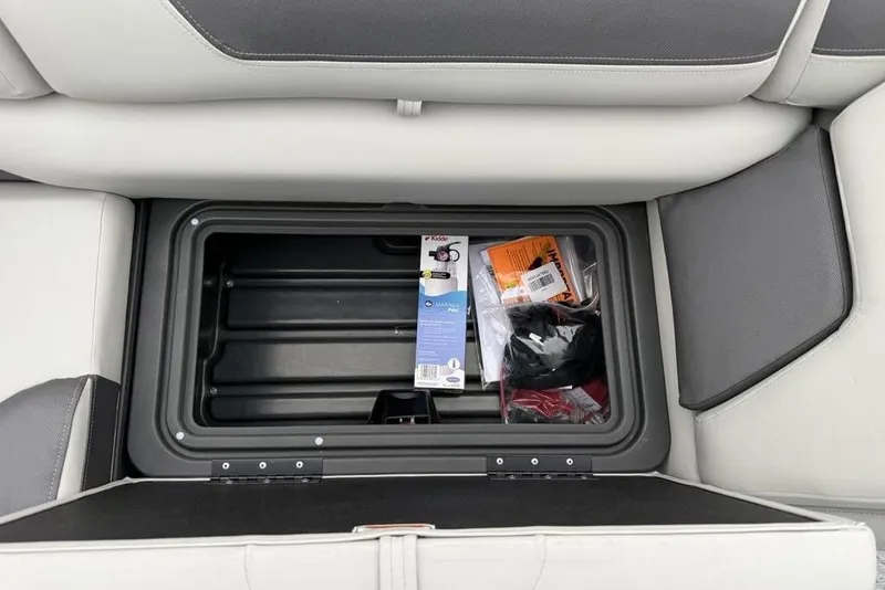 Slide: The Image of Storage compartment in 2026 Sun Tracker Fishin' Barge 20 DLX with fishing gear. - 23