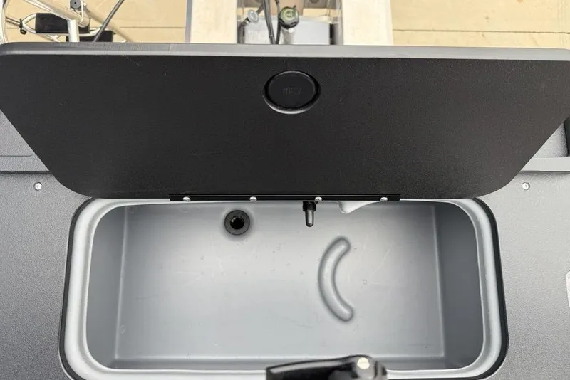 Slide: The Image of Open storage compartment on 2026 Sun Tracker Fishin' Barge 20 DLX boat. - 24