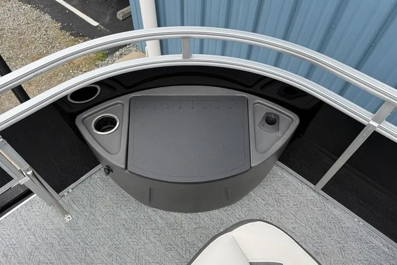 Slide: The Image of 2026 Sun Tracker Fishin' Barge 20 DLX deck with cup holders and storage. - 3