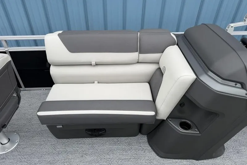 Slide: The Image of 2026 Sun Tracker Fishin' Barge 20 DLX interior seating with gray and white upholstery. - 8