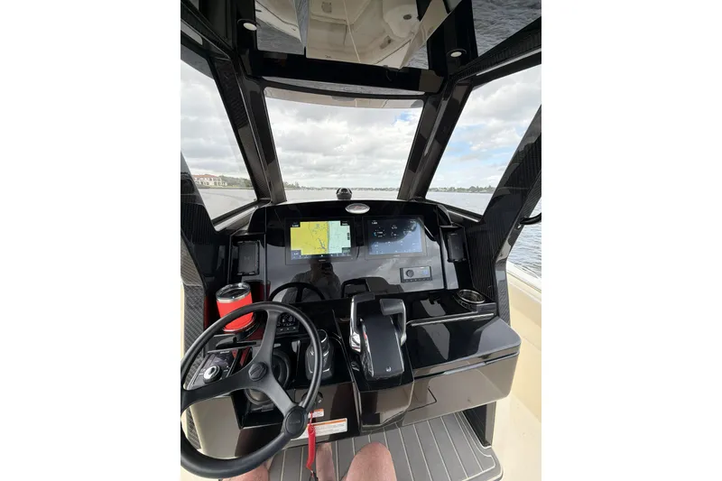 Slide: The Image of Helm of 2026 Scout 288 LXF boat with modern navigation displays and controls. - 6