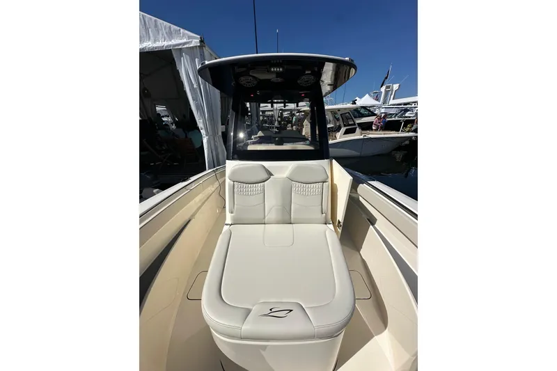 Slide: The Image of 2026 Scout 288 LXF boat interior with luxurious seating at a marina. - 8