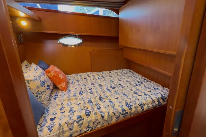 Slide: The Image of Cozy cabin interior of 2021 Mikelson Gen II 43 SF yacht with nautical-themed bedding. - 10