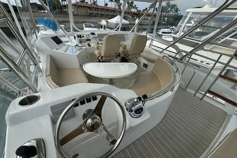 Slide: The Image of 2021 Mikelson Gen II 43 SF yacht cockpit with steering wheel and seating area. - 11